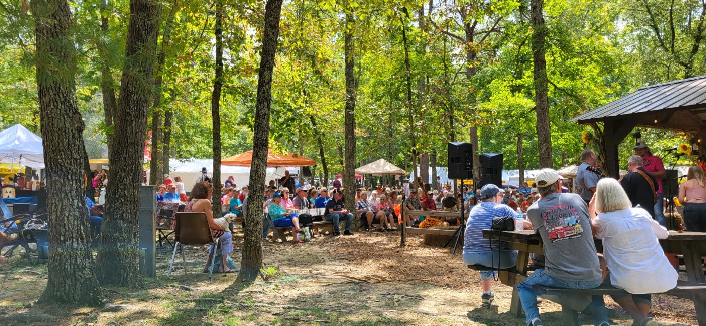 Visitors watching traditional musicians at the Mountaineer Folk Festival